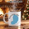 White mug with Newnans Lake, Florida design, steaming coffee, fireplace, and Christmas tree.