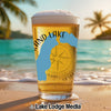 Glass of beer with "Grand Lake" text and Michigan map overlay on beach.