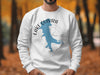 White sweatshirt with a blue Lake Quivira outline and compass rose graphic.