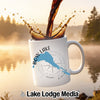 White mug with "Bow Lake Alberta" and compass design, coffee pouring into it.