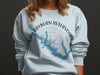 Light blue sweatshirt with Sam Rayburn Reservoir map graphic and compass.