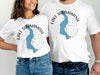 White t-shirts with blue Lake Sammamish silhouette and compass design.