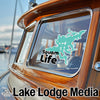 Turquoise Squam Lake sticker with "Squam Life" text on a boat window, "Lake Lodge Media" text below.