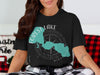 Black t-shirt features Forest Lake shape with compass and Minnesota text.