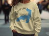 Light yellow sweatshirt with Augur Lake map graphic and compass rose.