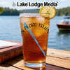 Glass of iced tea with "Pedro Island" and compass design, lemon slice garnish.