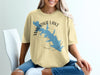 Yellow t-shirt with blue Waurika Lake Oklahoma map graphic and compass rose.