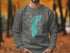 Grey sweatshirt with teal Lake Michigan outline and compass graphic.