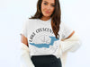 White t-shirt with "Lake Crescent Washington" in a compass design.