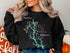 Black sweatshirt with "Beautiful Lake Oconee Georgia" and compass rose design.