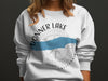 White sweatshirt with "Donner Lake California" text and compass design.
