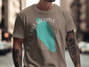 Tan t-shirt with turquoise Lake Mohave graphic and compass rose.