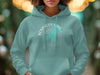Teal hoodie with Benbrook Lake, Texas compass graphic on chest.