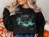 Black sweatshirt with Lake Amistad map and compass graphic.
