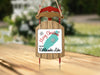 Sled ornament with "Merry Christmas From Rattlesnake Lake" text and snowflakes.