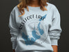 Light blue graphic sweatshirt with Reelfoot Lake Tennessee map and compass design.