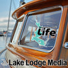 Lake Lodge Media sticker on a wooden boat window with a lake outline and the word Life.
