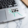 Pickwick Life sticker with teal lake outline on laptop keyboard.