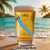 Glass of beer on beach with "Tisco Lake" text and compass design.