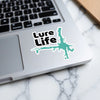 Lure Life sticker on a laptop with a lake outline and copyright text.