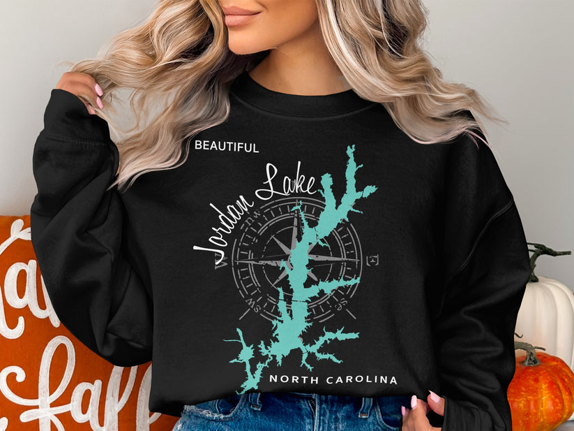 Black sweatshirt with turquoise Jordan Lake map and compass rose graphic.