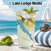Glass with beverage, lime, mint, and "Lake San Pablo" design on beach.