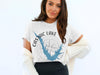 White t-shirt with blue Castaic Lake outline and compass graphic with "California" text.