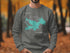 Grey sweatshirt with a teal map of Lake Arrowhead and compass rose.