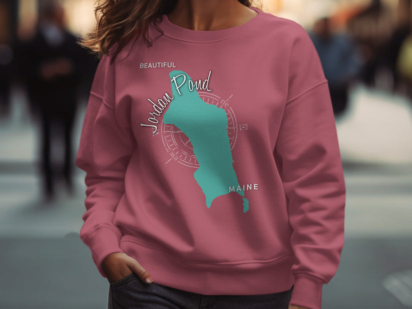 Pink sweatshirt with a teal map of Jordan Pond, Maine and compass rose.