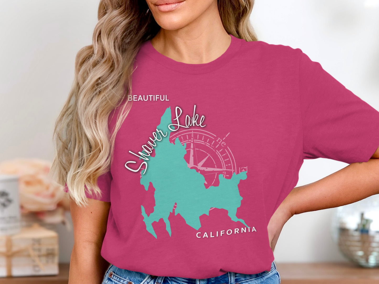 Woman wearing a pink t-shirt with a turquoise map of Shaver Lake, California.