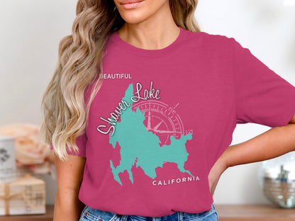 Woman wearing a pink t-shirt with a turquoise map of Shaver Lake, California.