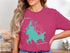 Woman wearing a pink t-shirt with a turquoise map of Shaver Lake, California.