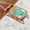 Wooden sled ornament with red runners and text "Merry Christmas From Lake Mary".