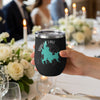 Black tumbler with Shaver Lake map and compass design, held by a hand.