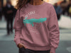 Dusty rose sweatshirt with Enid Lake Mississippi map logo and compass design.