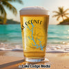 Glass of beer with "Lake Oconee Georgia" map and compass design on a beach.
