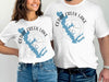 White t-shirts featuring the Cedar Creek Lake map with a compass rose graphic.
