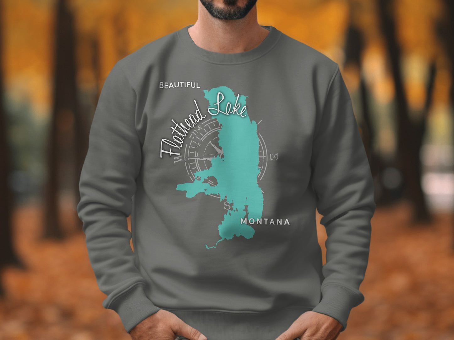 Sweatshirt with turquoise Flathead Lake, Montana map and compass graphic.