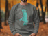 Sweatshirt with turquoise Flathead Lake, Montana map and compass graphic.