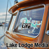 Dardanelle Life sticker on a boat window, Lake Lodge Media logo below.