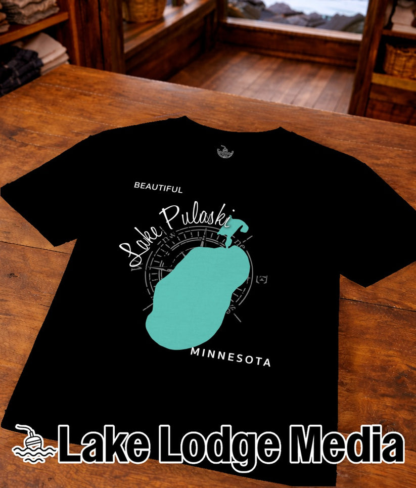 Black t-shirt featuring Lake Pulaski, Minnesota outline and "Lake Lodge Media" logo.