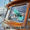 Window decal with "Onondaga Life" text and a boat graphic on a wooden boat.
