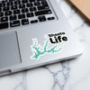 Shasta Life sticker with turquoise lake outline graphic on laptop keyboard.