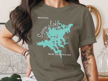 Teal Squam Lake map outline graphic on t-shirt worn by a person.
