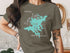Teal Squam Lake map outline graphic on t-shirt worn by a person.