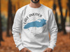 White sweatshirt with "Lake America" and compass graphic featuring a blue lake outline.