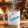 White mug with Lake Erie map and compass design, steaming coffee.