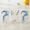 Three clear glasses display the blue outline of Lake Pend Oreille and compass rose.