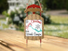Wooden sled ornament with "Merry Christmas from Woods Canyon" text and snowflakes.