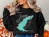 Black sweatshirt with a teal map outline of Ross Barnett Lake, Mississippi.